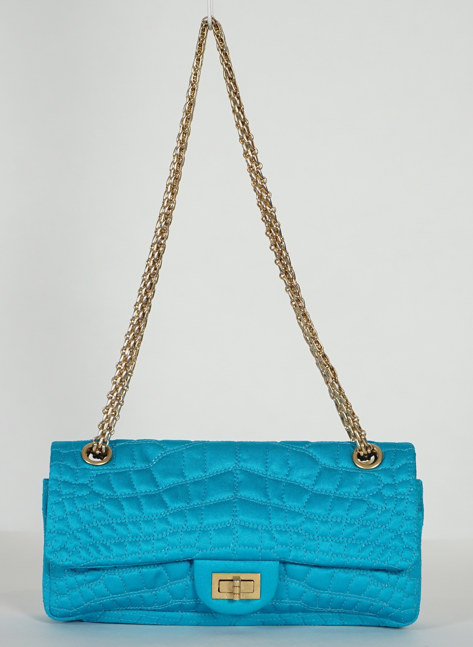 A Chanel medium-sized 2-55 bag in turquoise blue silk satin stitched with a quilted crocodile pattern, width 24cm, height 15cm, depth 6cm, Single handle 112cm, Double handles 65cm